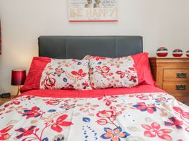 A bedroom with a bed and nightstand at Linden Lea Field Broughton near Cartmel