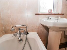 A bathroom with a bathtub and sink at Linden Lea Field Broughton near Cartmel