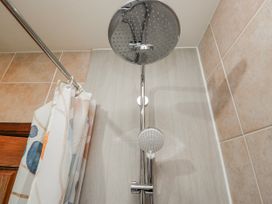 A shower with a shower head and curtain in Linden Lea Field Broughton near Cartmel