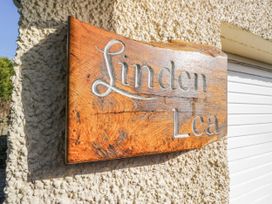A wooden sign with the name Linden Lea on an exterior wall