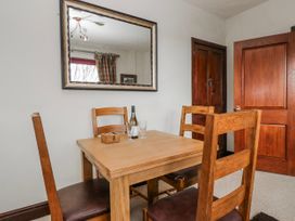 A dining room with a table and chairs at Linden Lea Field Broughton near Cartmel