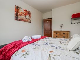A bedroom with a bed and towels on it at Linden Lea Field Broughton near Cartmel