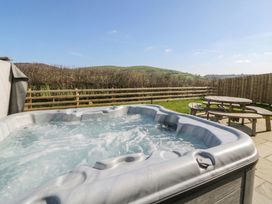 A hot tub with outdoor seating at Daverneithon 4 near Llandrindod Wells