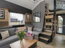 A living room with a staircase and couch at Daverneithon 4 near Llandrindod Wells