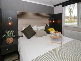 A bedroom with a bed, pillows, and a tray with snacks at Daverneithon 4 near Llandrindod Wells
