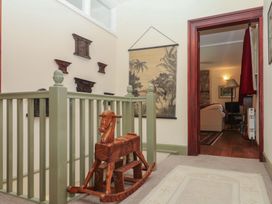 A hallway with a rocking horse and wall decor at Lukesland Wing in Ivybridge