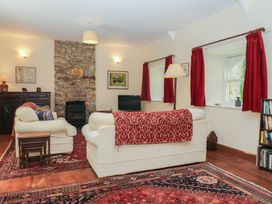 A living room with a sofa and fireplace at Lukesland Wing in Ivybridge