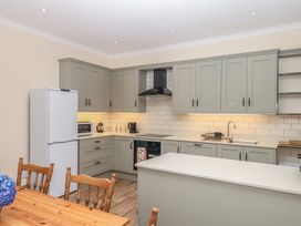 A kitchen with appliances and cabinets at Lukesland Wing in Ivybridge