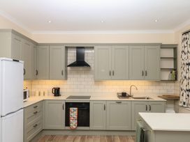 A kitchen with cabinets appliances and a sink at Lukesland Wing Ivybridge