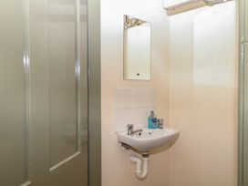 A bathroom with a sink and mirror at Lukesland Wing in Ivybridge