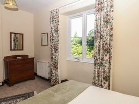 A bedroom with a dresser and window at Lukesland Wing Ivybridge