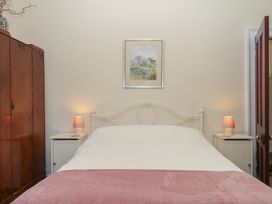 A bedroom with a bed and lamps at Lukesland Wing in Ivybridge