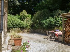 An outdoor area with a table and chairs at Lukesland Wing Ivybridge
