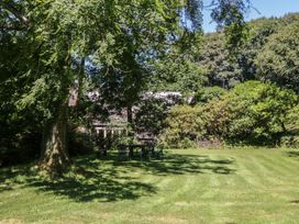 A garden with a table and chairs at Lukesland Wing Ivybridge
