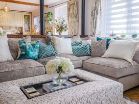 A living room with a sofa and coffee table at The Coach House in Dorchester