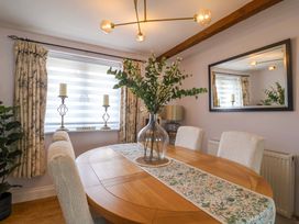A dining room with a table and chairs at The Coach House in Dorchester