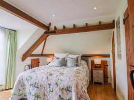 A bedroom with a bed and bedside table at The Coach House in Dorchester
