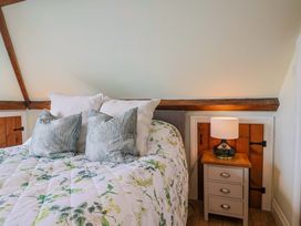 A bedroom with a bed and bedside table at The Coach House in Dorchester