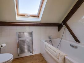 A bathroom with a bathtub and a toilet at The Coach House in Dorchester