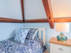 A bedroom with a bed and bedside table at The Coach House in Dorchester