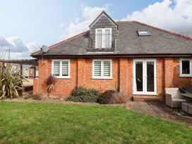 A building with windows and patio furniture at The Coach House in Dorchester