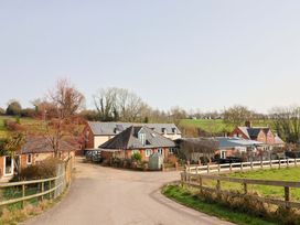 An outdoor view of multiple houses and greenery at The Coach House in Dorchester