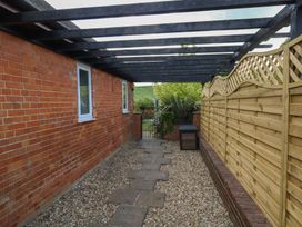 An outdoor space with a path and fencing at The Coach House Near Charminster