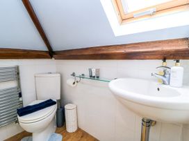 A bathroom with a toilet and sink at The Coach House Near Charminster
