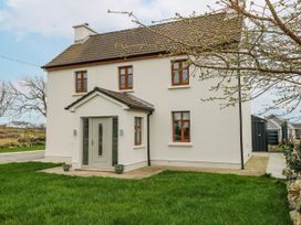 A house with a pathway and grass at Ballina in Inverin