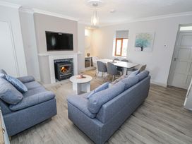 A living room with a television and fireplace at Ballina in Inverin
