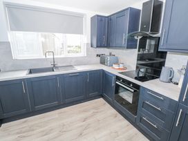 A kitchen with cabinets and appliances at Ballina in Inverin