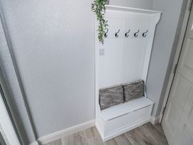 An entryway with a bench and hooks for coats at Ballina in Inverin