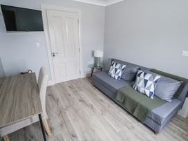 A living room with a sofa and a television at Ballina in Inverin