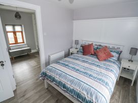 A bedroom with a bed and window at Ballina in Inverin