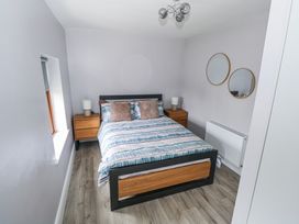 A bedroom with a bed and nightstands at Ballina in Inverin