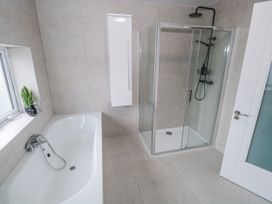 A bathroom with a shower and bathtub at Ballina in Inverin