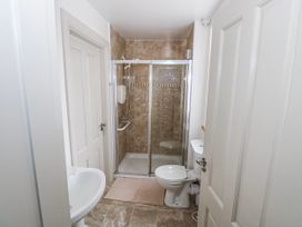 A bathroom with shower, toilet, and sink at Ballina in Inverin