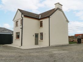 A house with multiple windows and a door at Ballina in Inverin