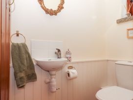 A bathroom with a sink and toilet at The Cottage in Sampford Courtenay
