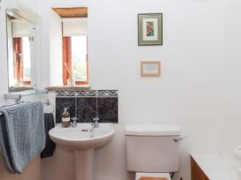 A bathroom with a sink and toilet at The Cottage in Sampford Courtenay