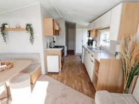 A kitchen with a stovetop and sink at 75 Morpeth Mews Wooler