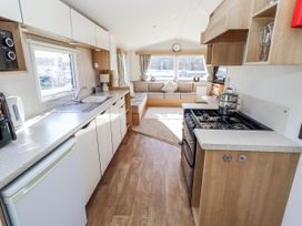 A kitchen with a sofa and dining area at 75 Morpeth Mews Wooler