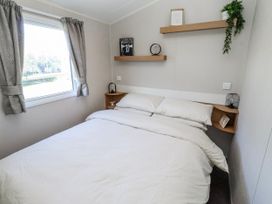 A bedroom with a bed and window at 75 Morpeth Mews Wooler