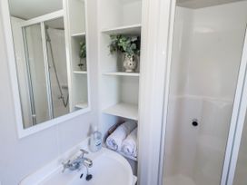 A bathroom with a sink and shower at 75 Morpeth Mews Wooler