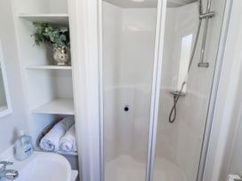 A bathroom with a shower and sink at 75 Morpeth Mews in Wooler
