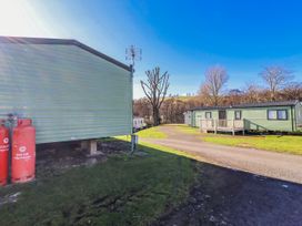 An outdoor area with caravans and propane tanks at 75 Morpeth Mews Wooler