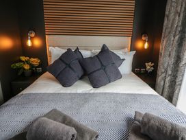 A bedroom with a bed and pillows at Dawn's Rest in Nantmel near Rhayader