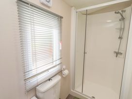 A bathroom with a shower and toilet at Gardeners Lodge