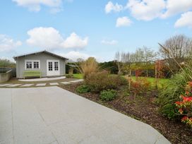 A garden with a shed and a green bench at Sunnyside in River Chapel