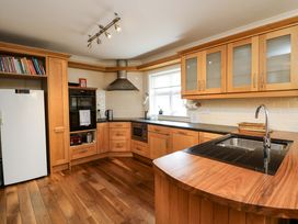 A kitchen with cabinets and appliances at Sunnyside River Chapel
